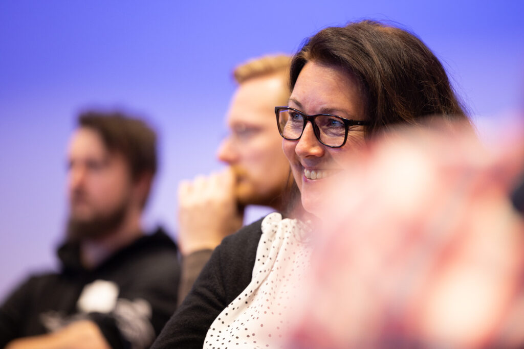 Smilende kollega påUpheads seminar